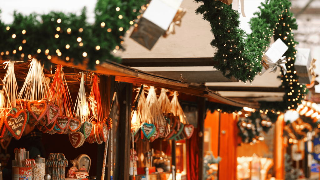 Wooden Christmas Market hut with christmas decorations, and lit up by sparkly christmas lights